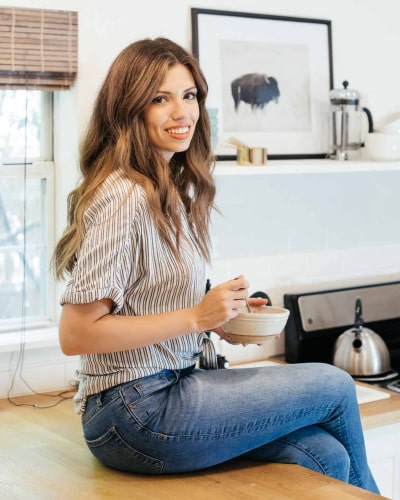 Christine in her kitchen with a bowl of yogurt parfait