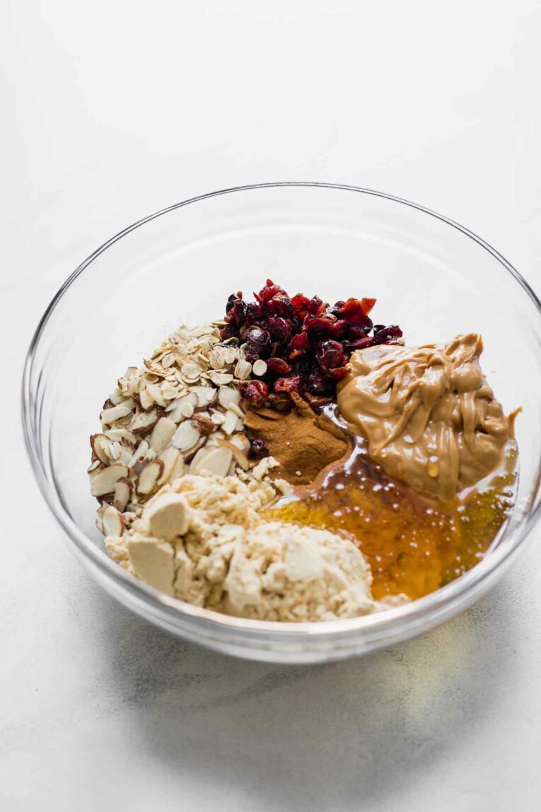 Ingredients for Cranberry Almond Healthy Oatmeal Bars in a mixing bowl.