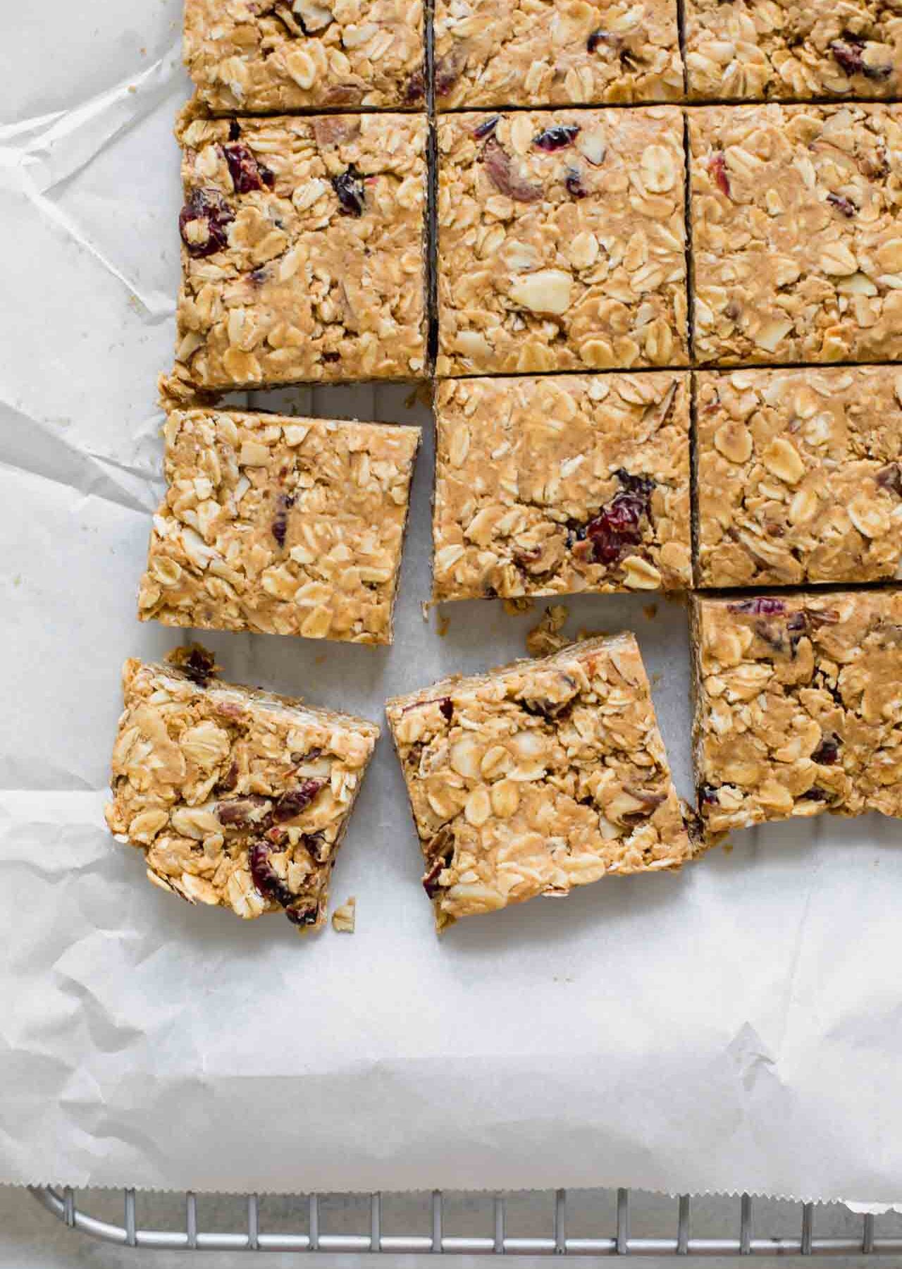 Cranberry Almond Healthy Oatmeal Bars on white parchment paper.