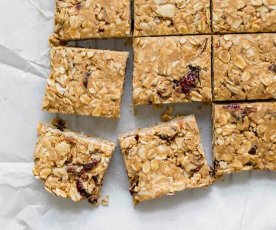 Cranberry Almond Healthy Oatmeal Bars on white parchment paper.
