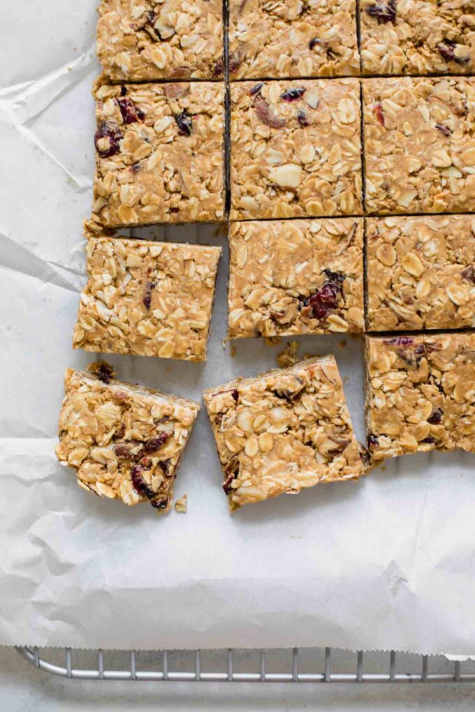 Cranberry Almond Healthy Oatmeal Bars on white parchment paper.