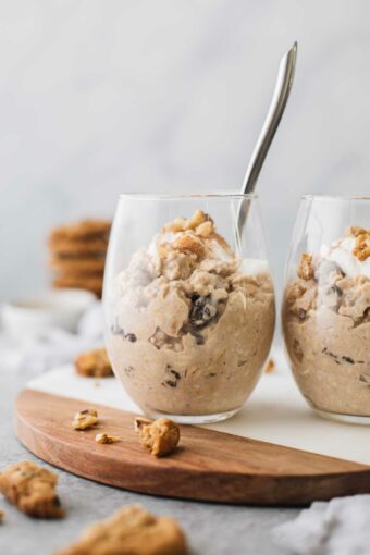 Oatmeal Cookie overnight oats in two glass cups with a spoon.