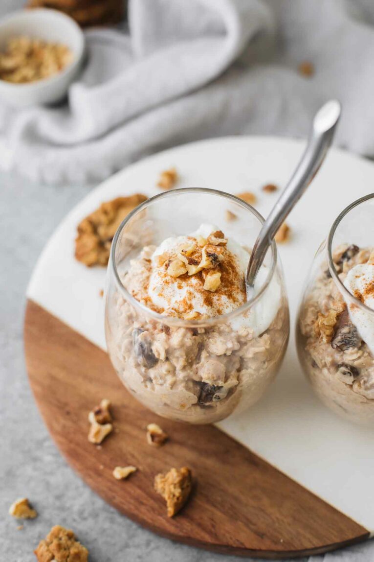Angled shot of oatmeal cookie overnight oats with raisins, greek yogurt, cinnamon, and walnuts.