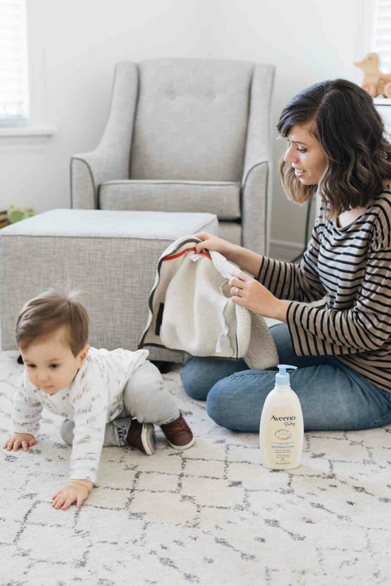 Toddler and mom getting ready in nursery.