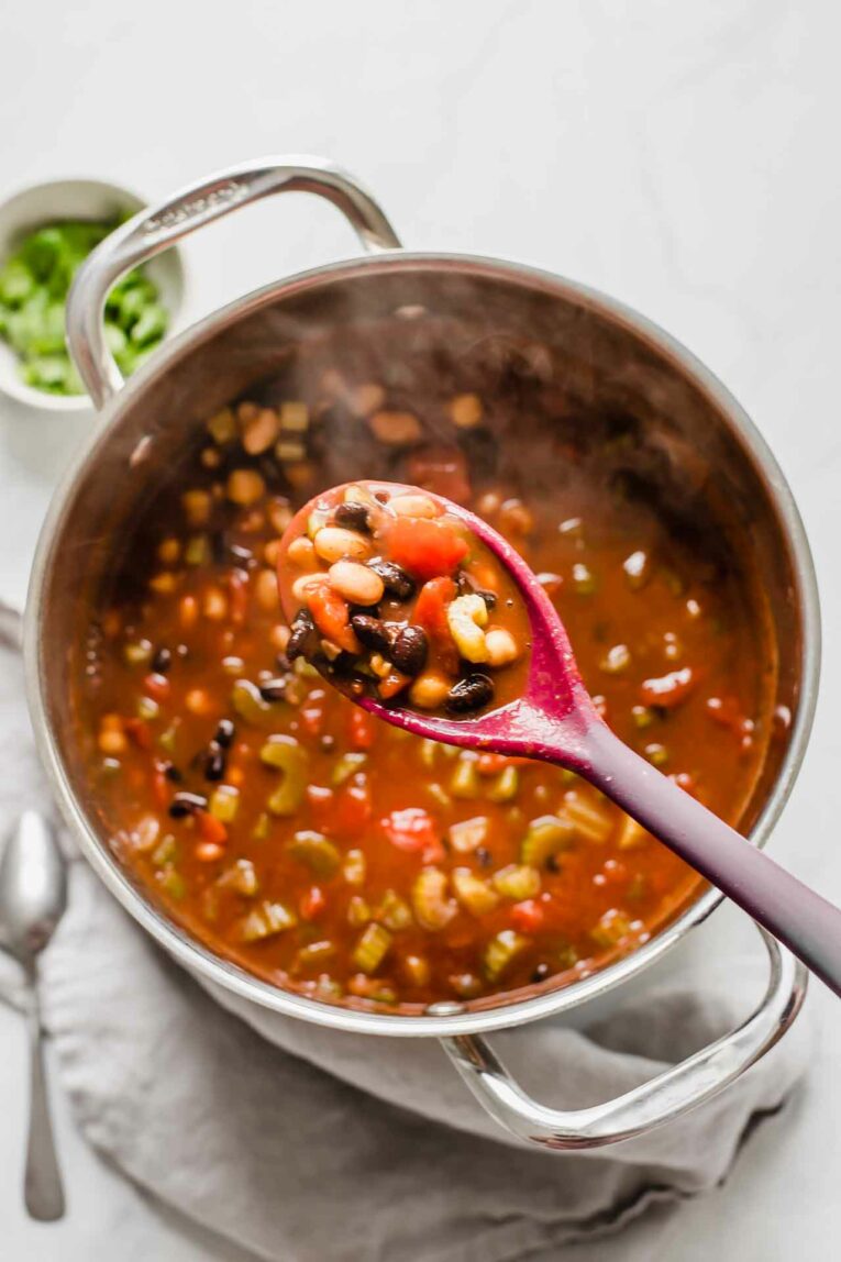 Large pot of vegan chili with a spoon.
