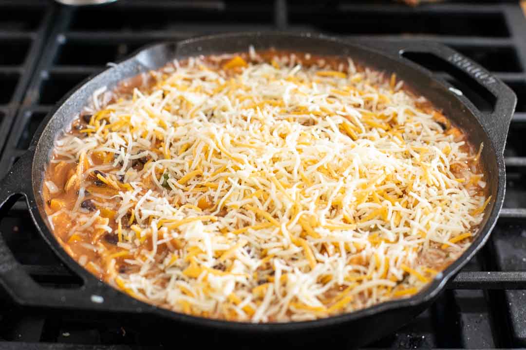Chicken Enchilada Skillet topped with shredded cheese.