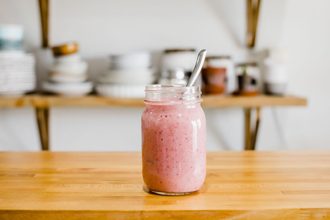 Strawberry smoothie on a counter top.
