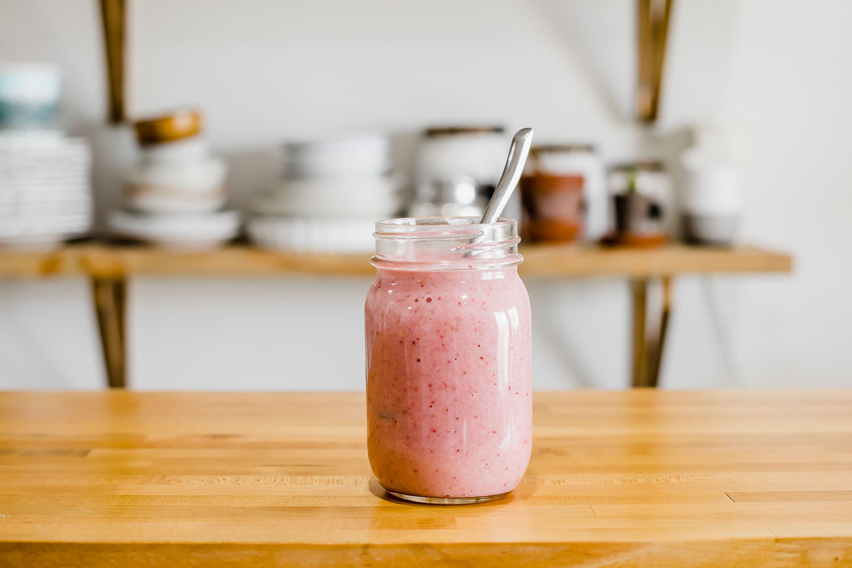 Strawberry smoothie on a counter top.