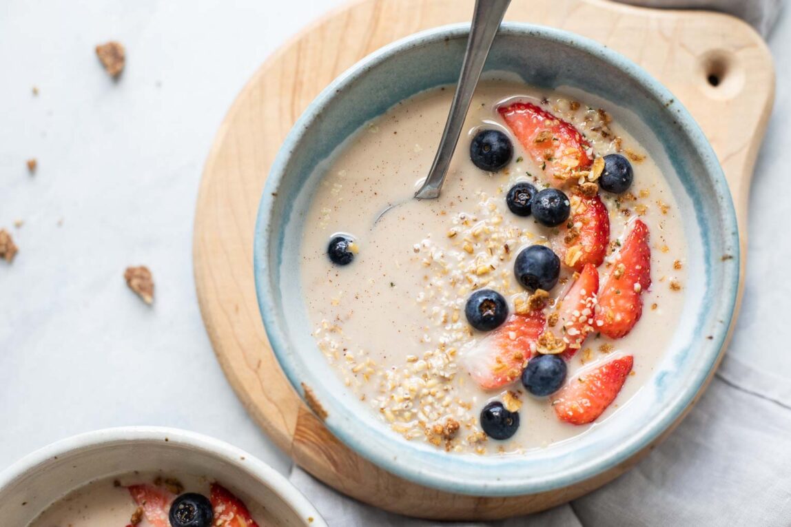 Top shot of steel cut overnight oats with berries and milk.
