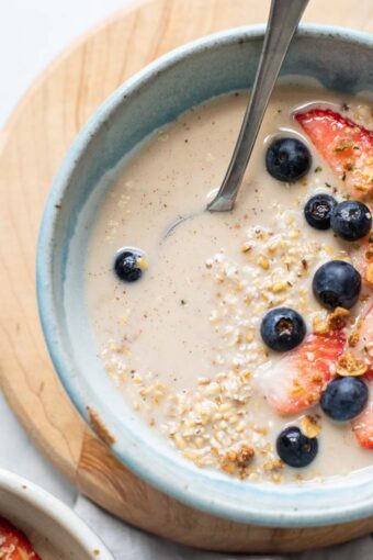 Top shot of steel cut overnight oats with berries and milk.