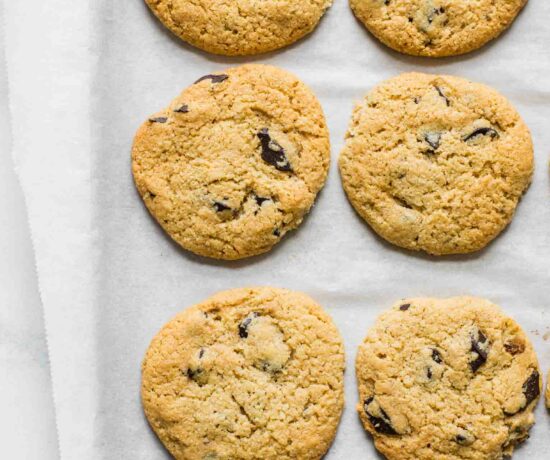 Close up of almond flour chocolate chip cookies on a baking sheet.