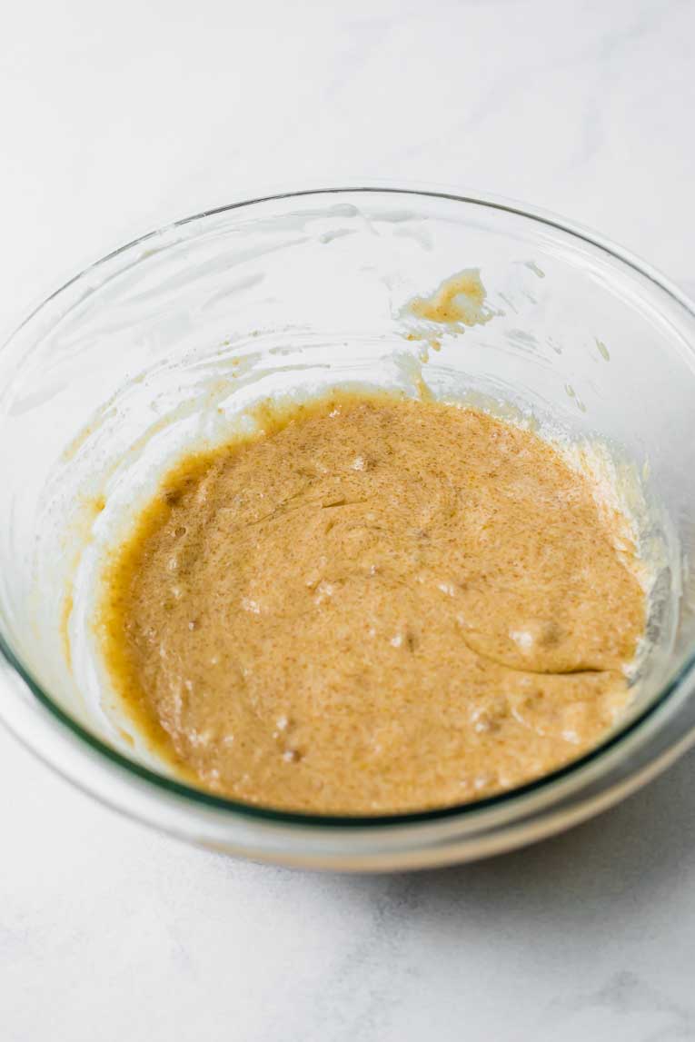 Eggs, sugar, butter, and vanilla mixed together in a glass bowl.