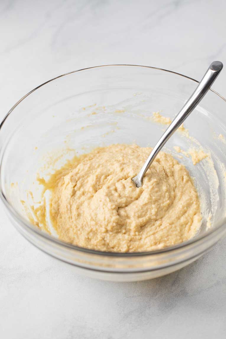 Doughnut dough in a large glass mixing bowl.
