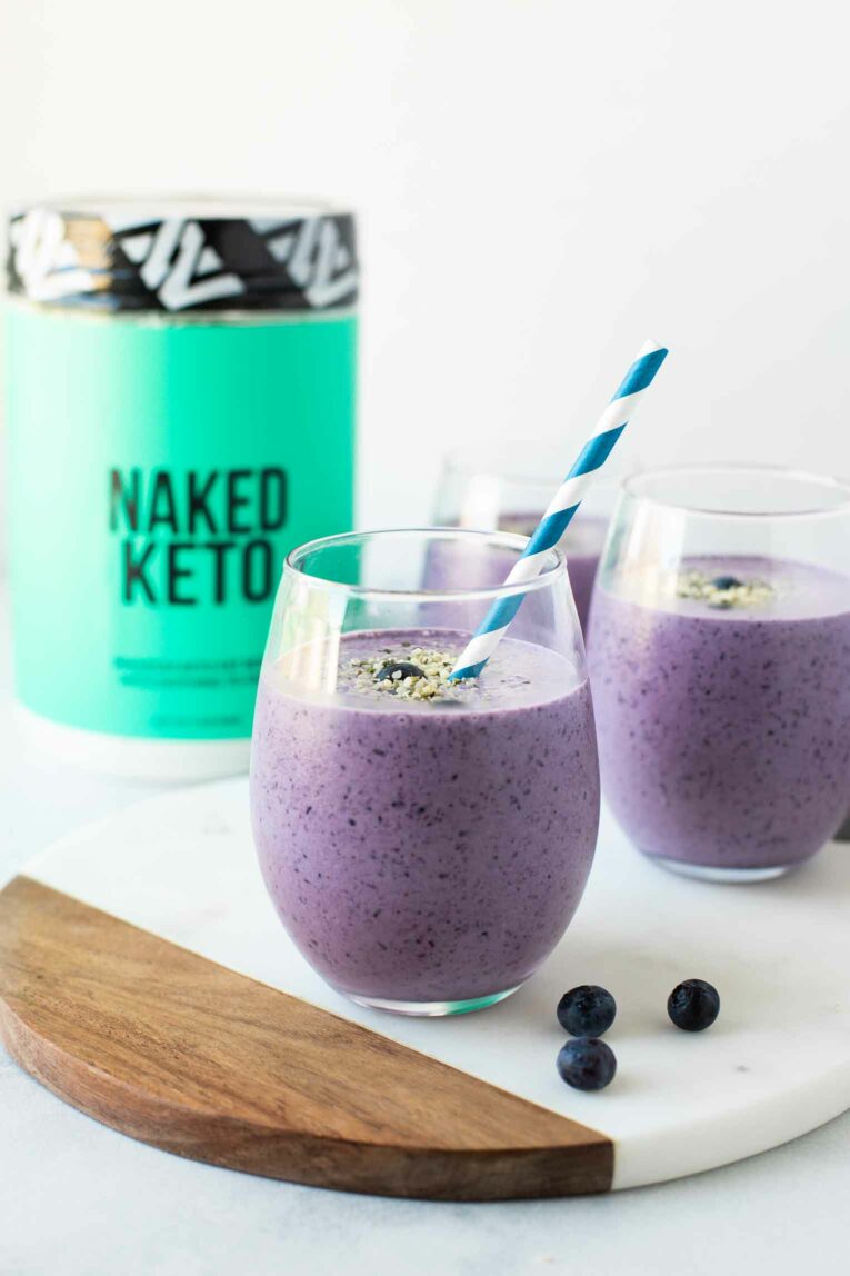 2 glasses of Blueberry Keto Smoothie in front of Naked Keto supplement jar.