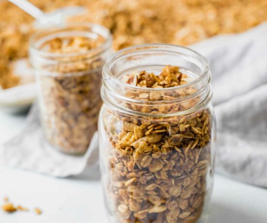 Close up of healthy granola in a mason jar with a napkin in the background.