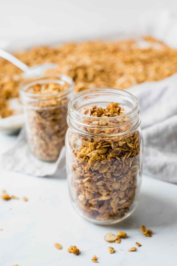 Close up of healthy granola in a mason jar with a napkin in the background.