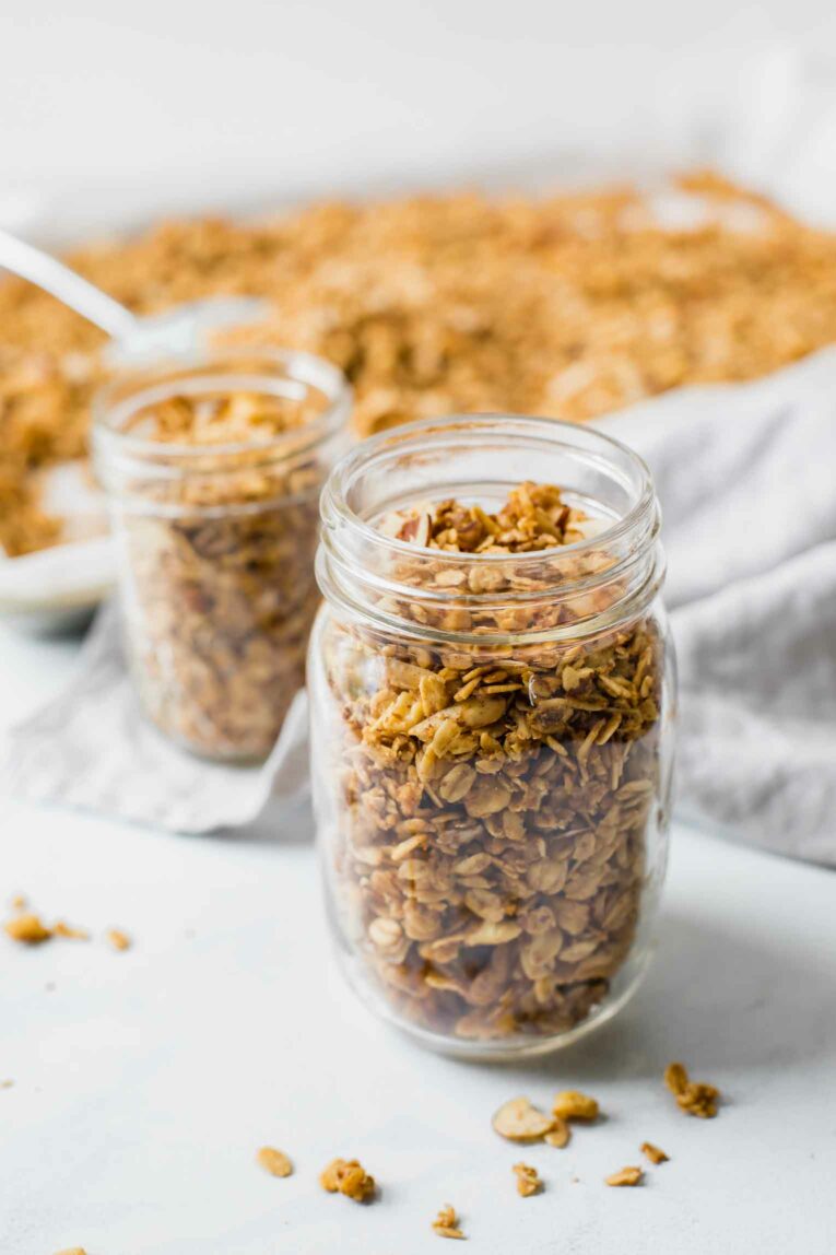 Close up of healthy granola in a mason jar with a napkin in the background.