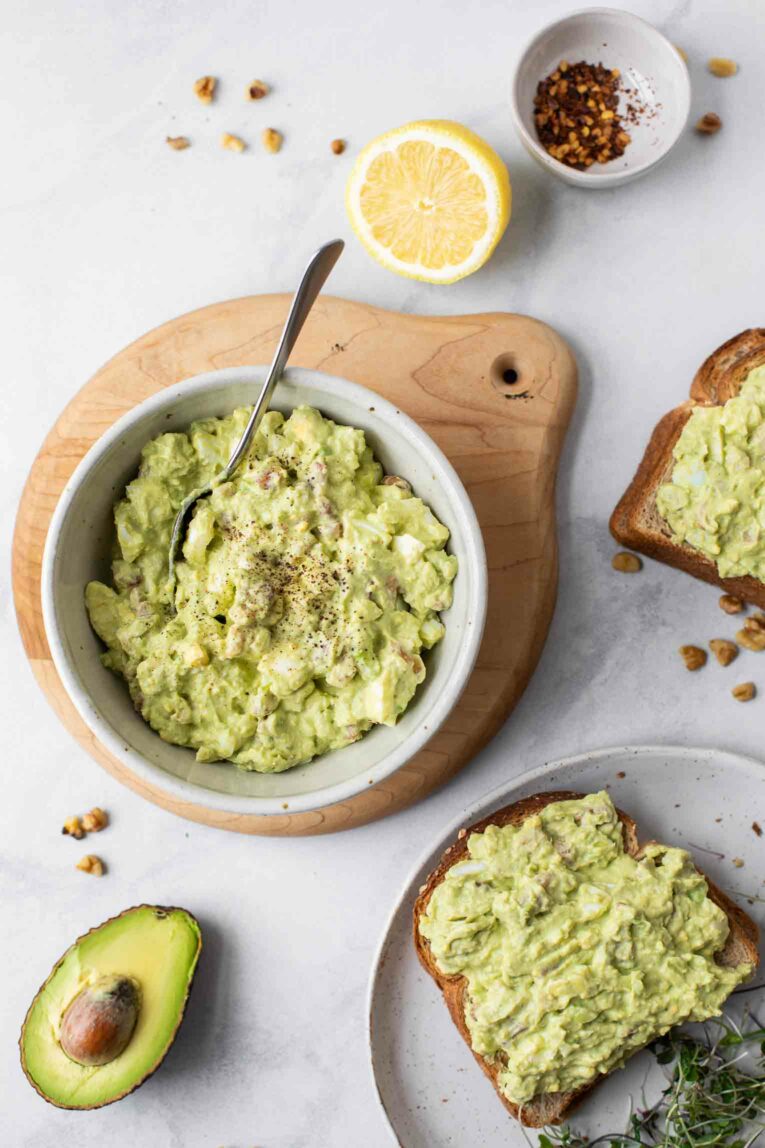 Top shot of green egg salad in a bowl and on toast.