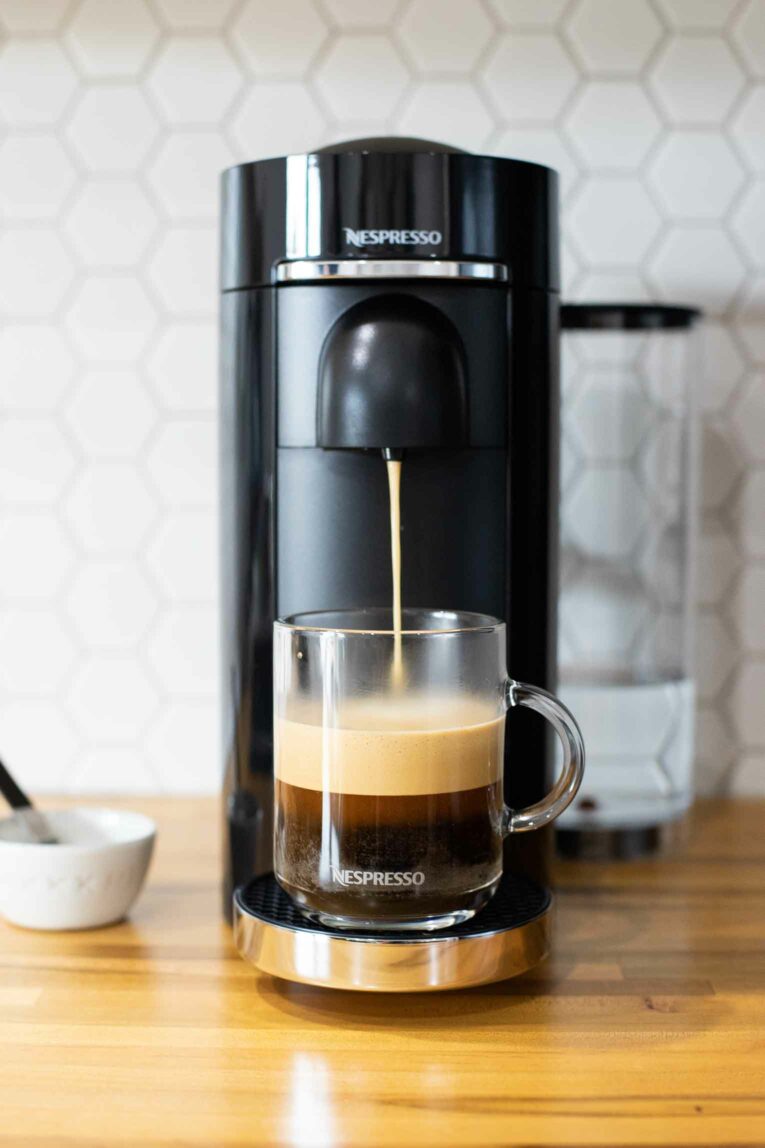 Nespresso coffee being brewed with foam.