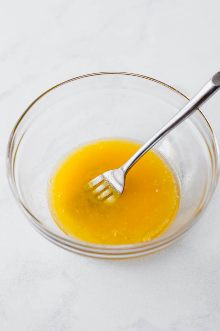 Eggs, baking soda, and butter in a glass mixing bowl.