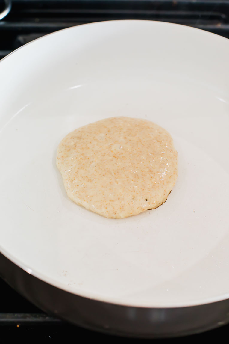 Sourdough pancake cooking on a skillet.