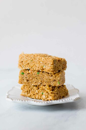 Across shot of healthy rice krispie treats stacked on a plate.