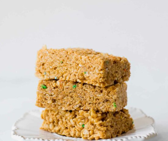 Across shot of healthy rice krispie treats stacked on a plate.