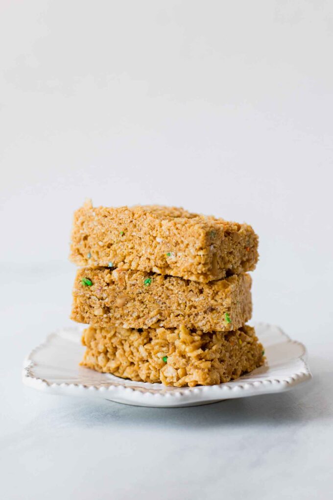 Across shot of healthy rice krispie treats stacked on a plate.