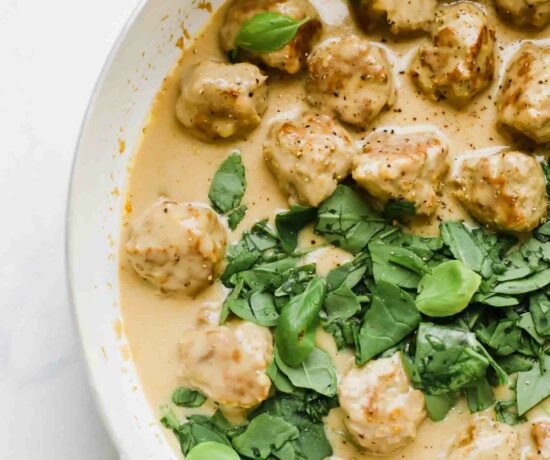 Close up of Swedish meatballs in a saucepan with gravy.
