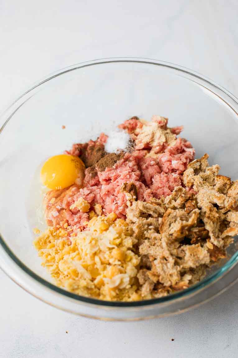 Meatball ingredients in a glass bowl.