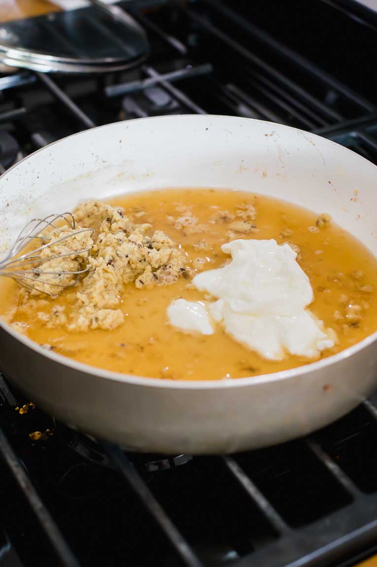 Butter, almond flour, yogurt, and broth in a saucepan.