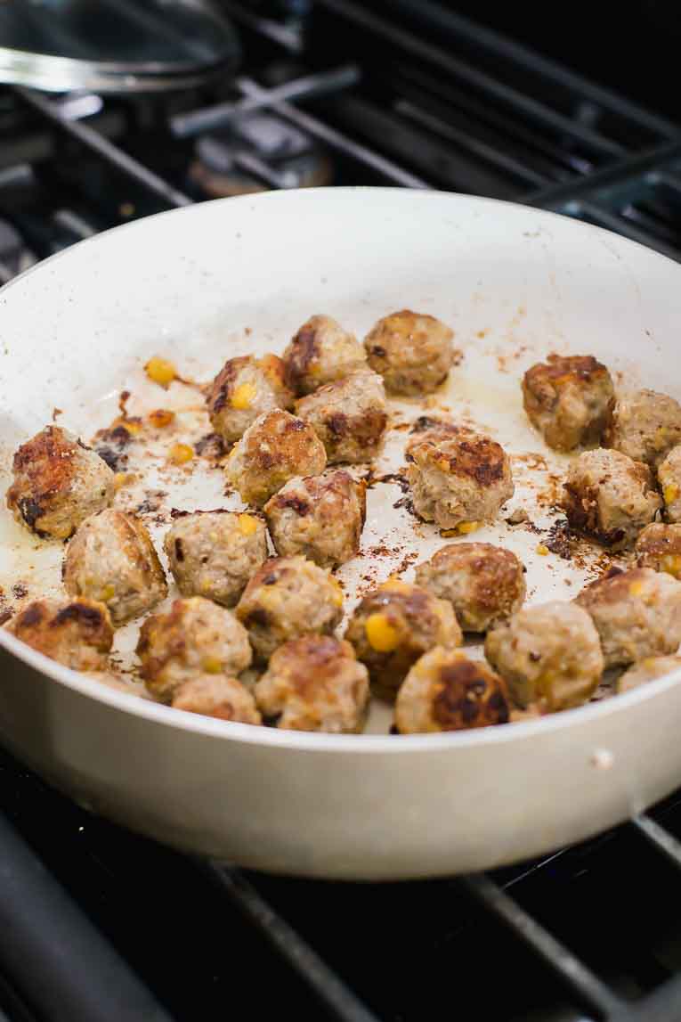Cooked meatballs in a saucepan.