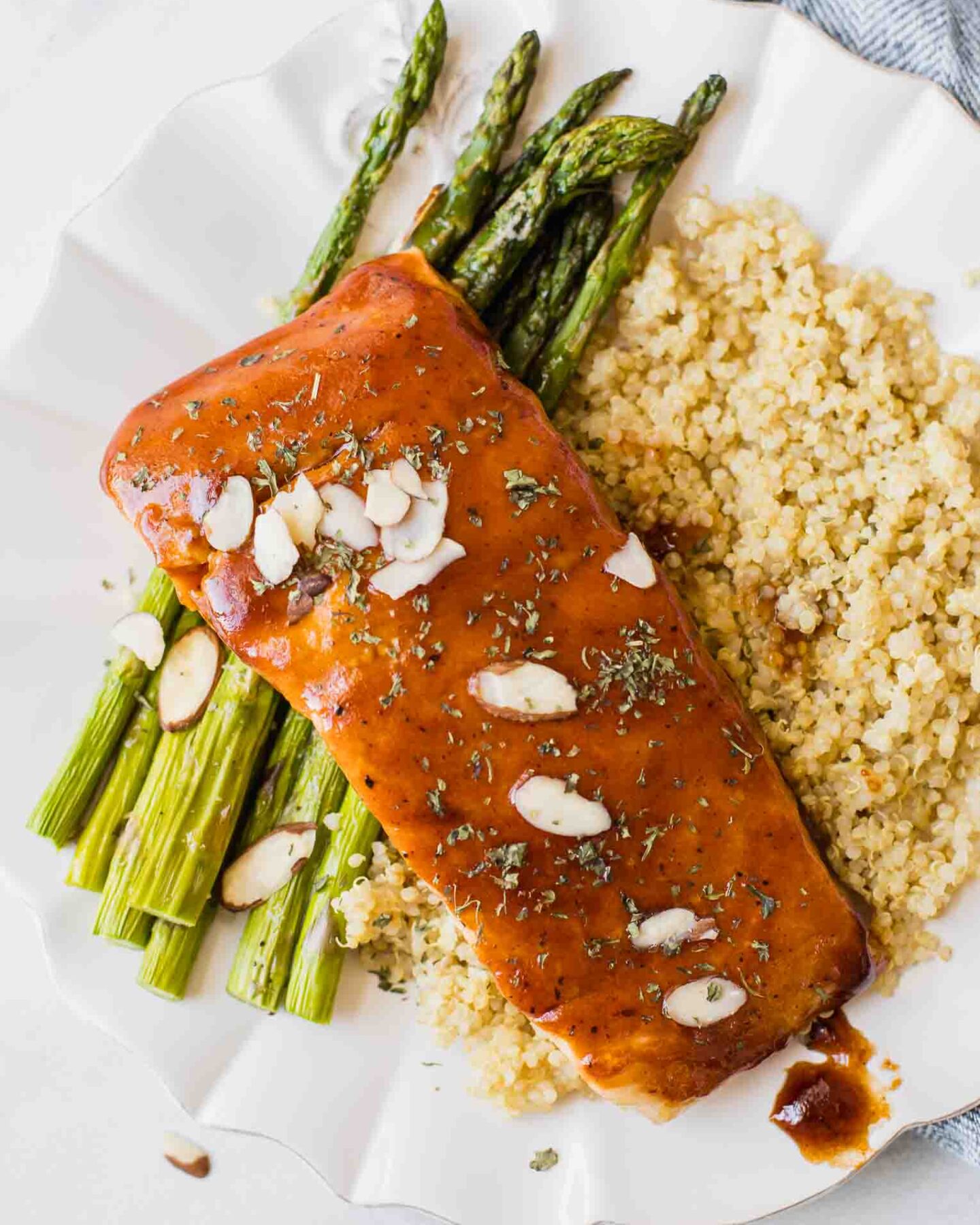 Close up of maple barbecue salmon topped with sliced almonds.