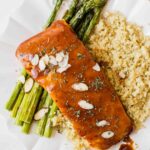 Close up of maple barbecue salmon topped with sliced almonds.