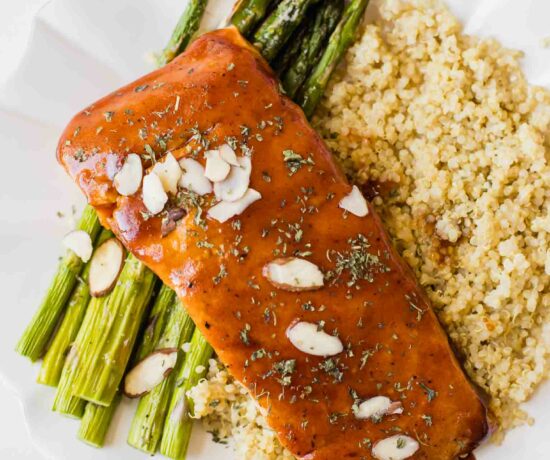 Close up of maple barbecue salmon topped with sliced almonds.