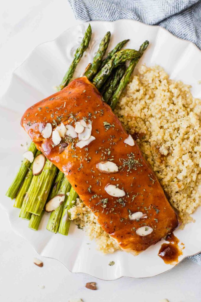 Close up of maple barbecue salmon topped with sliced almonds.