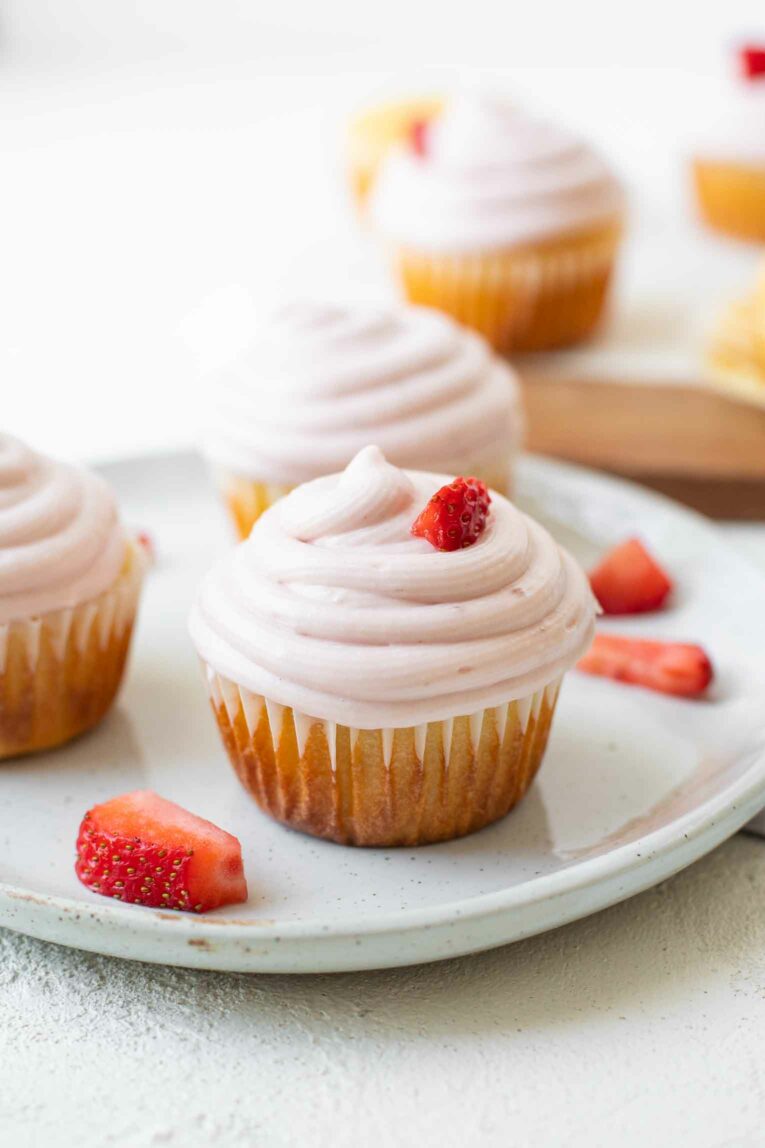 Close up of Strawberry Lemonade Cupcake on a white plate.