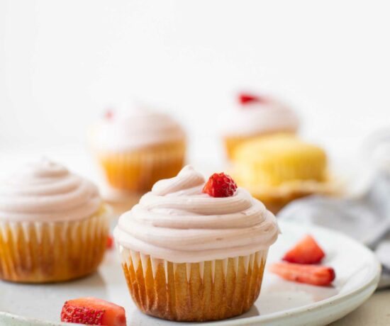 Across shot of Strawberry Lemonade Cupcakes on a white plate.