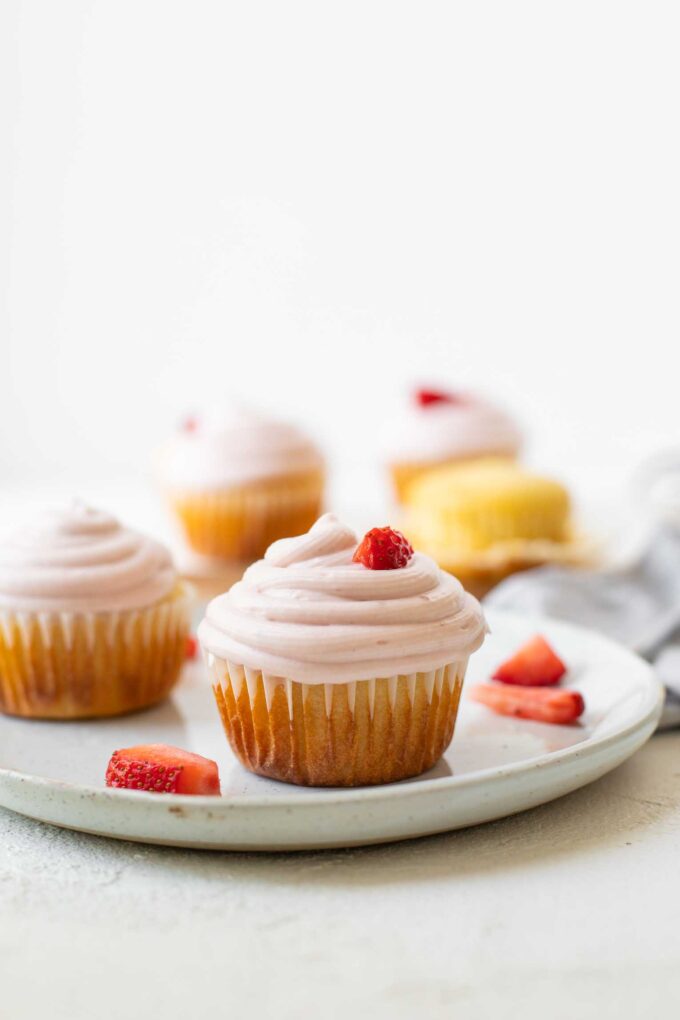 Across shot of Strawberry Lemonade Cupcakes on a white plate.