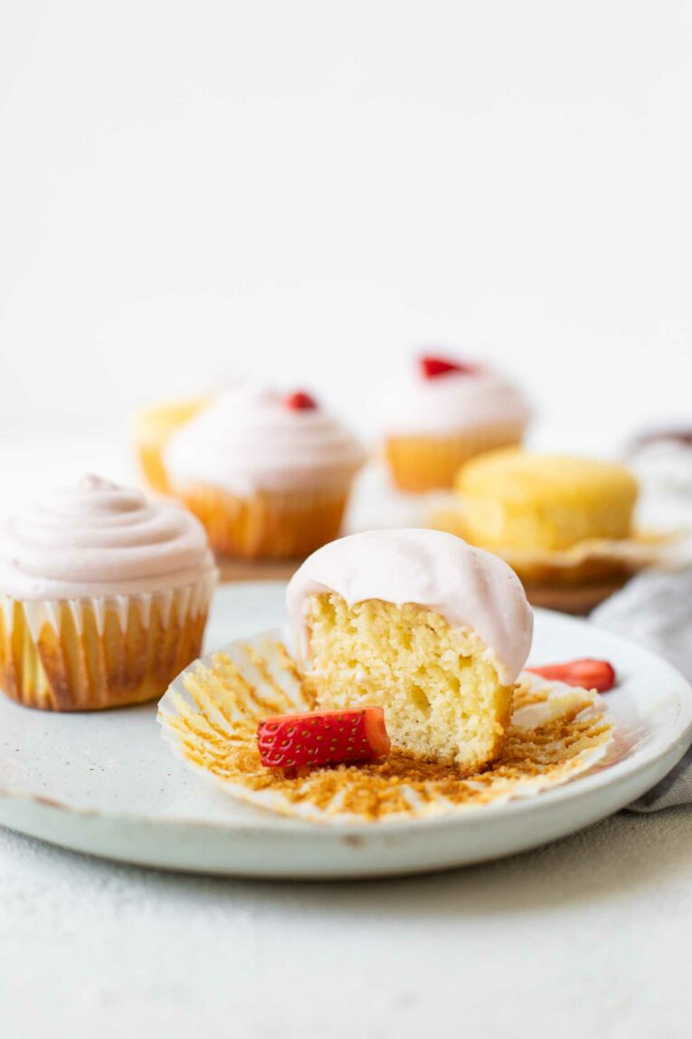 Strawberry Lemonade Cupcake with cream cheese icing cut in half.
