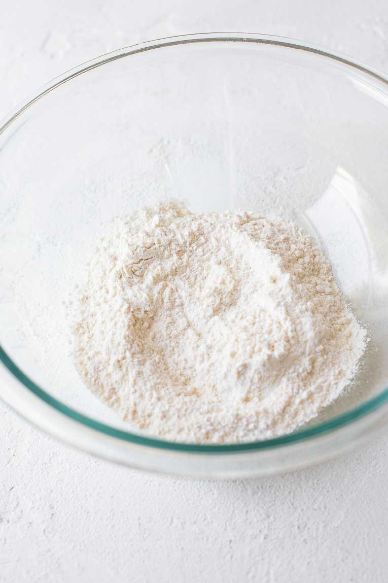 Dry ingredients for cupcakes in a glass mixing bowl.