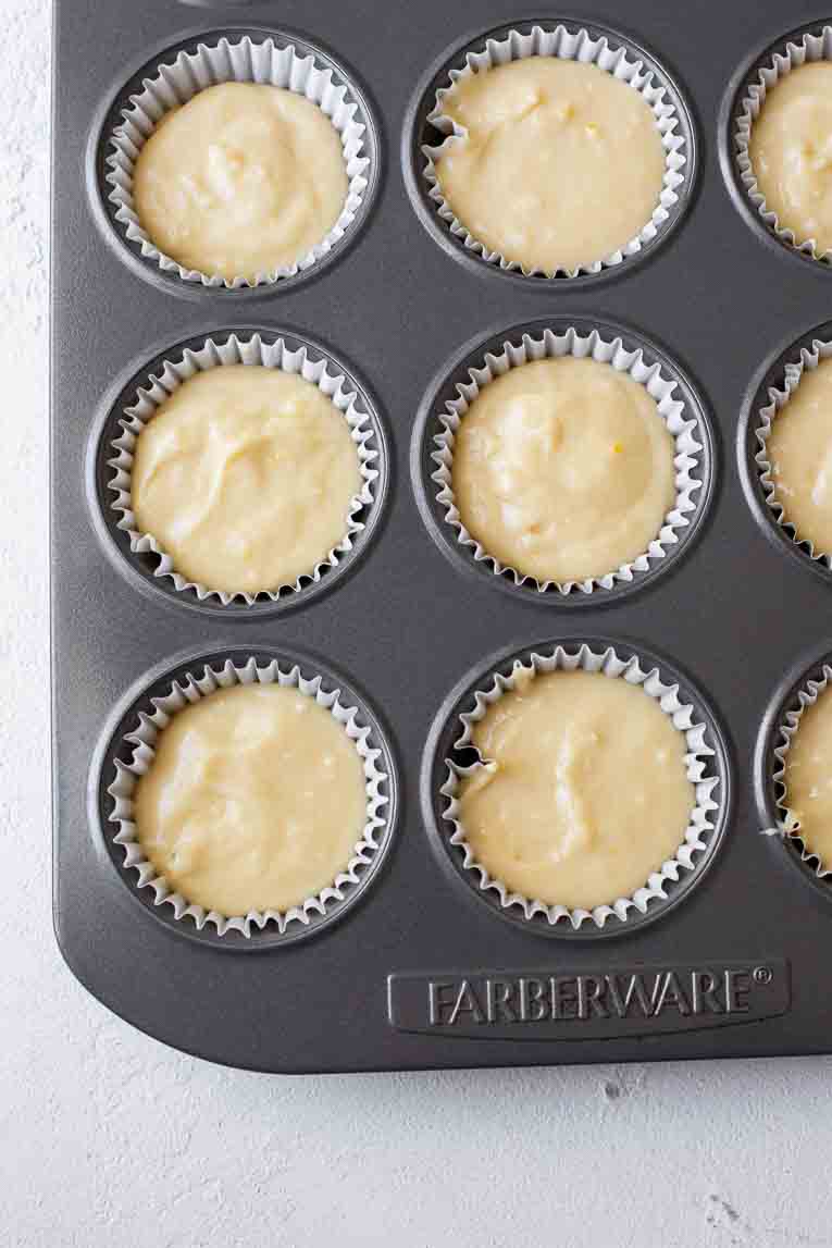 Cupcake batter poured into a lined cupcake pan.