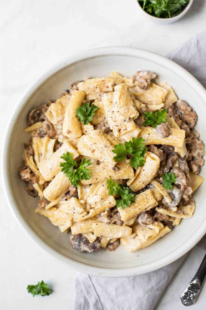 Top shot of Creamy Mushroom Sausage Rigatoni in a white bowl.