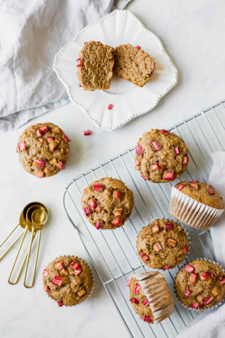 Styled top shot of Gluten-Free Healthy Rhubarb Muffins on a cooling rack.