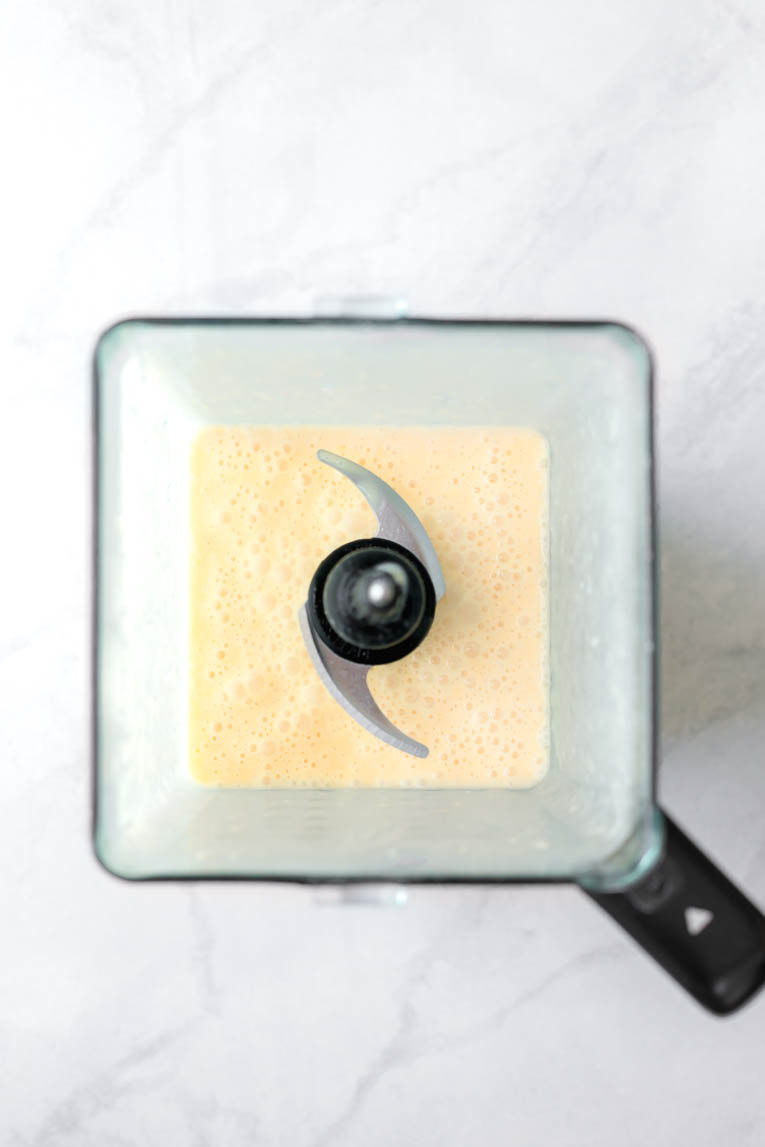 Peach popsicles blended in a blender.