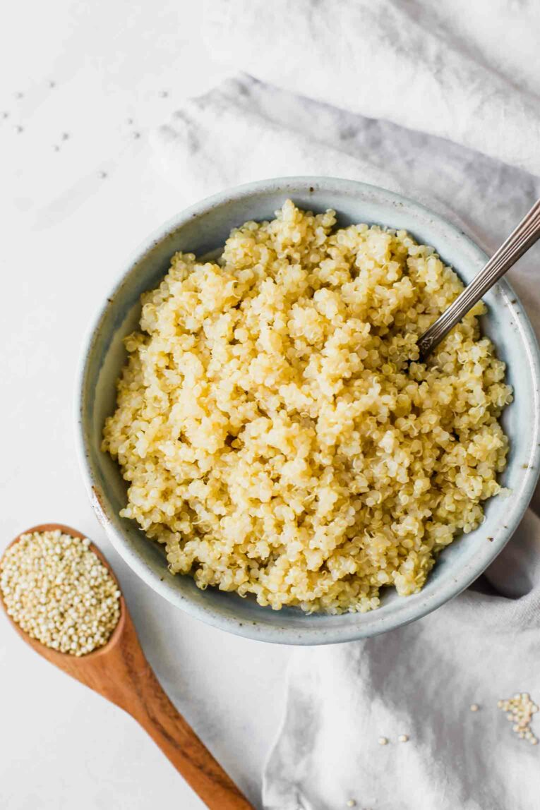 Top shot of cooked quinoa in a bowl with a fork.