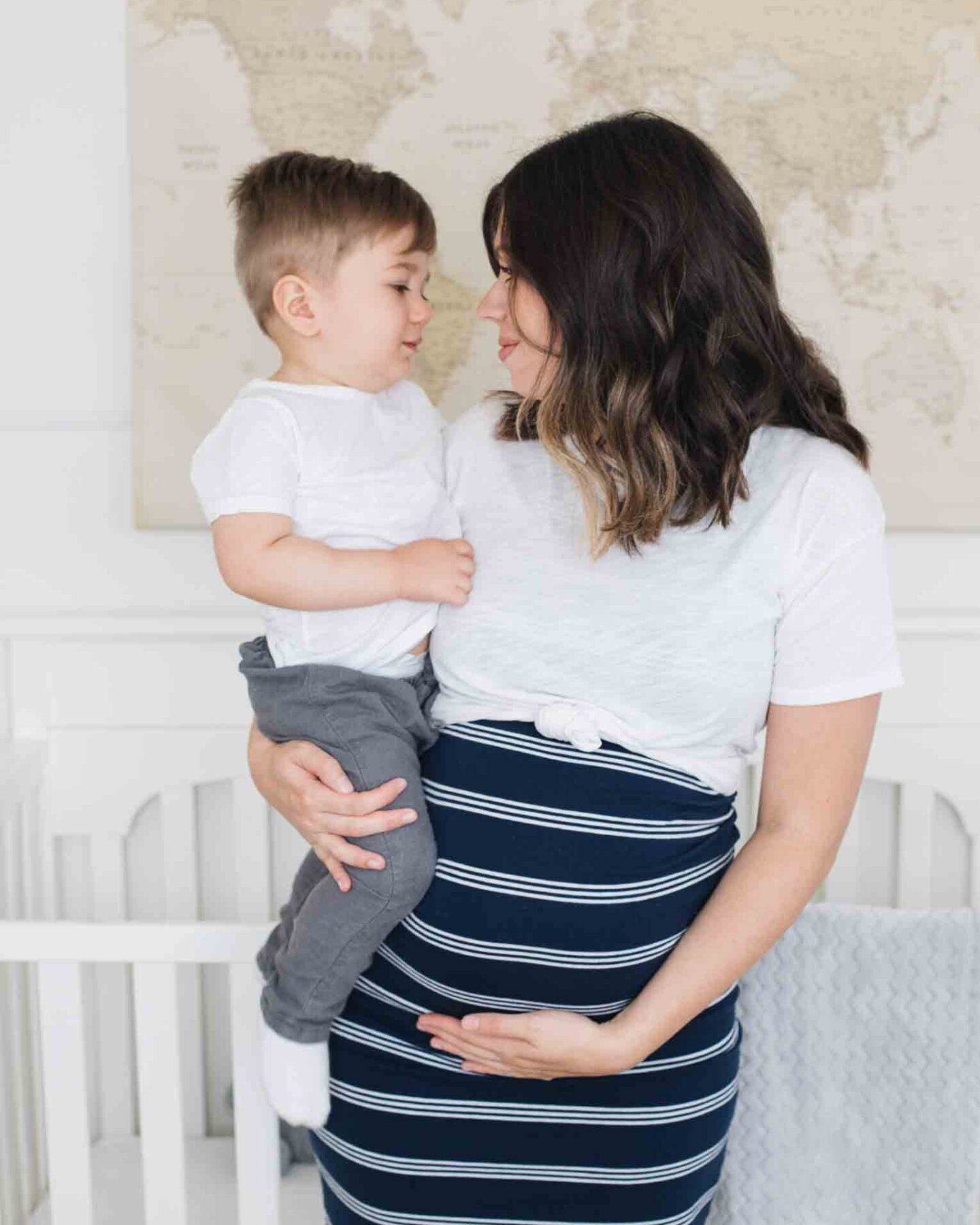 Pregnant mom holding toddler.