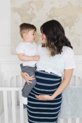 Pregnant mom holding toddler.