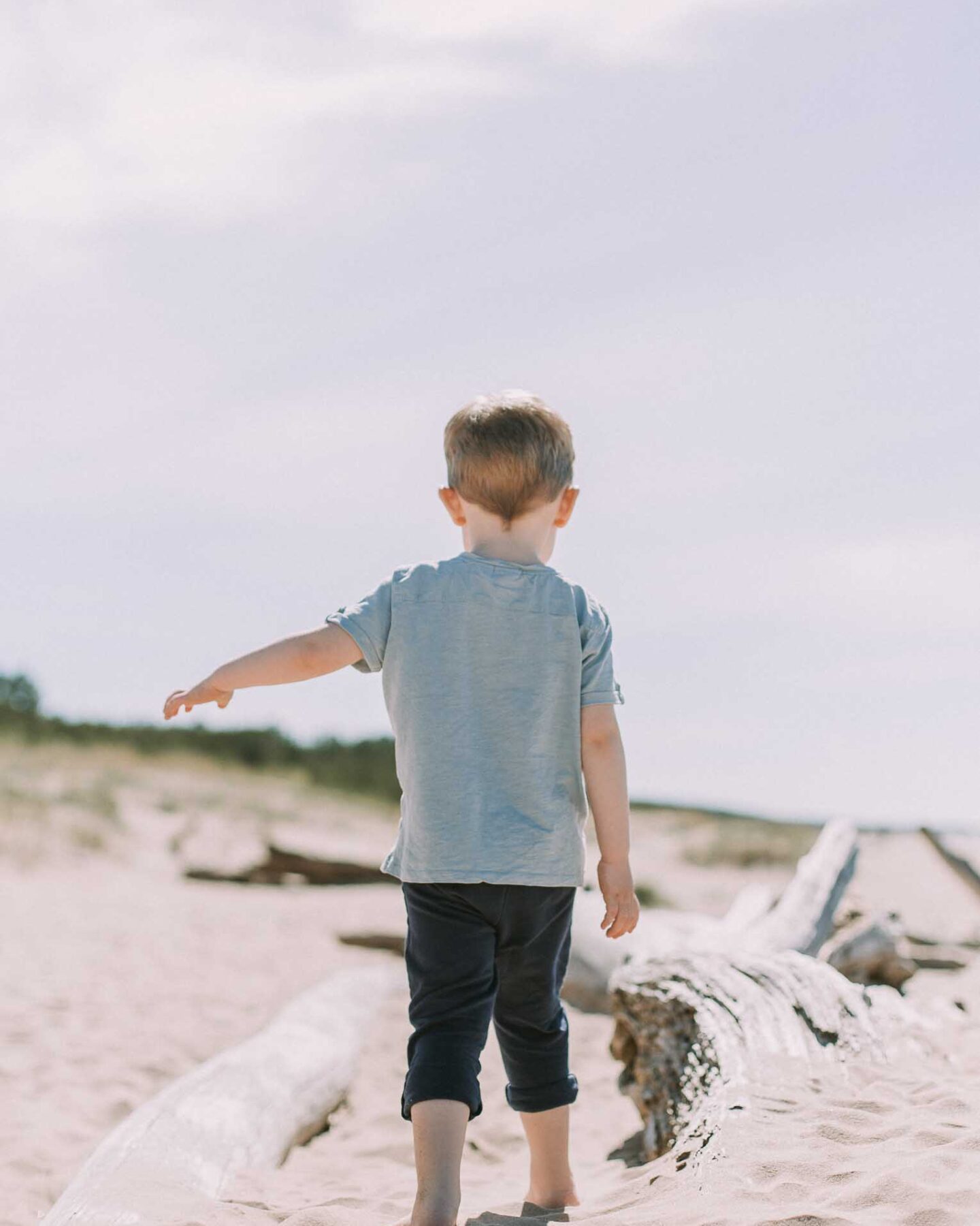 Toddler walking outside in the summer.