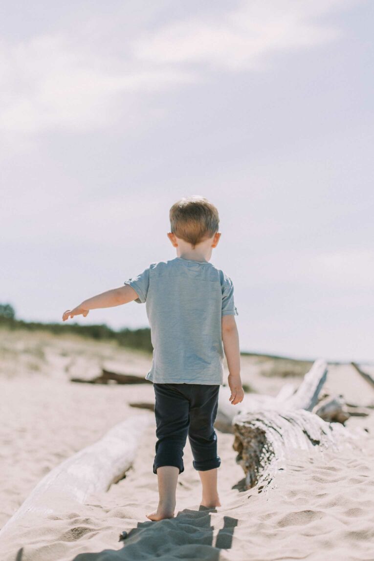 Toddler walking outside in the summer.
